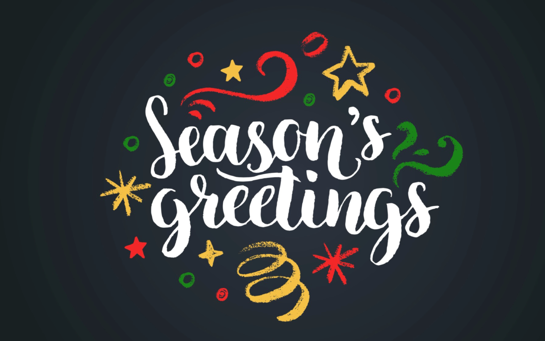 Christmas season's greetings lettering on a dark background.